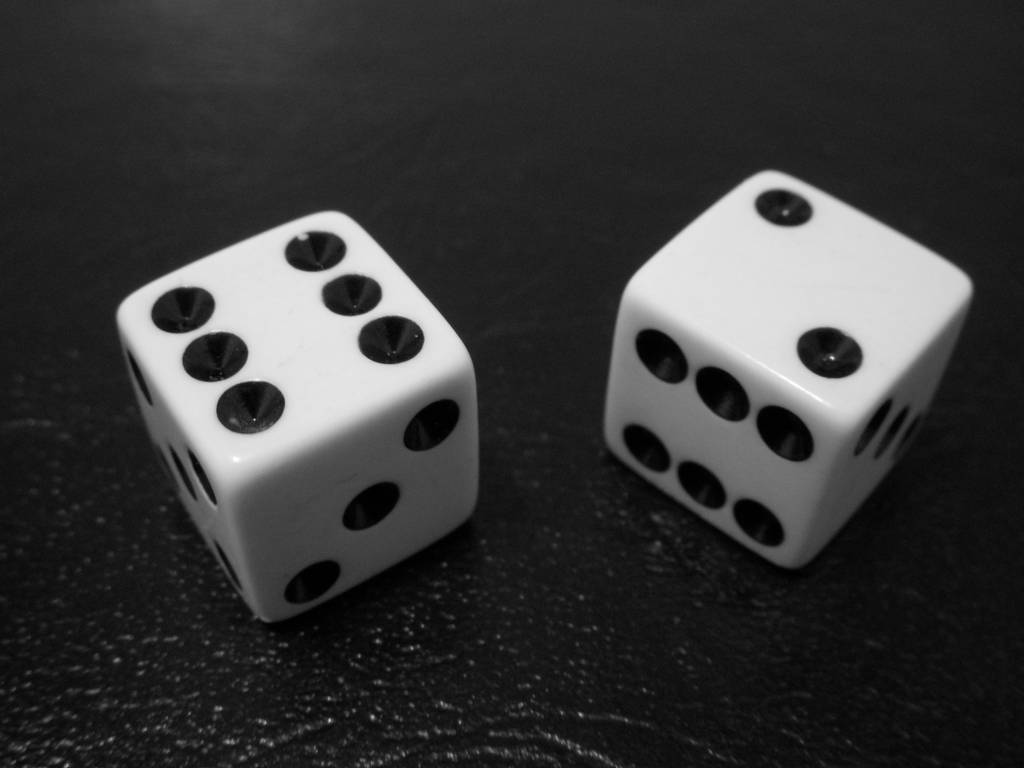 two white dices sitting on top of a table