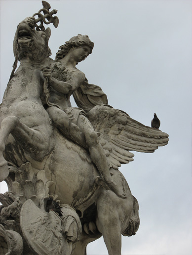 statue of angel on the back of a horse with wings