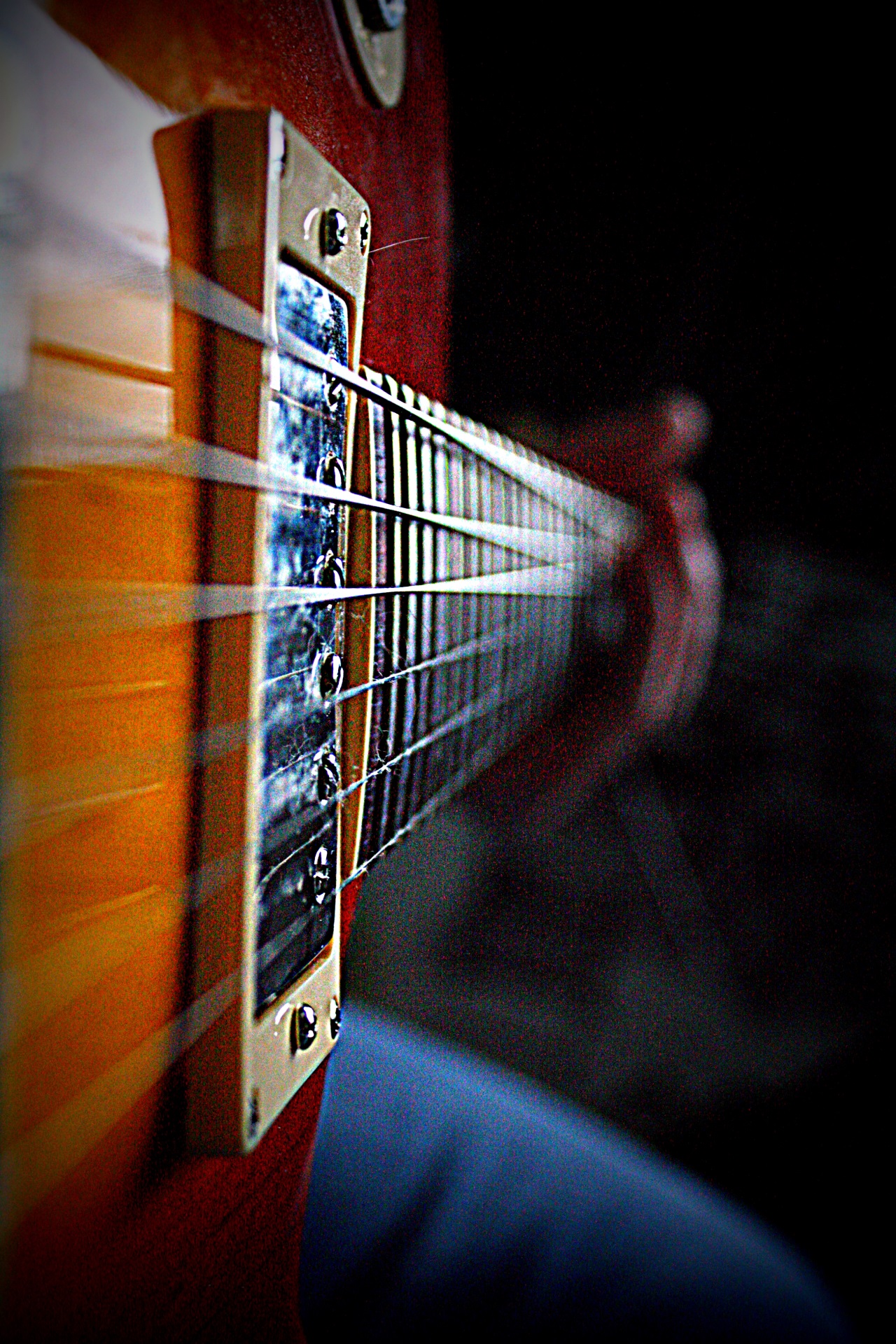 a person holding a guitar strings with their hands