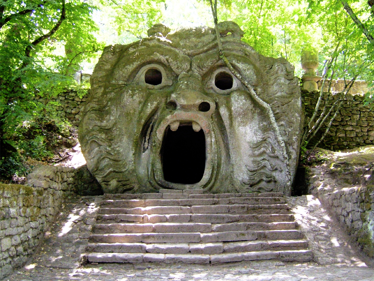 steps lead up to a large stone structure that has a face carved into it