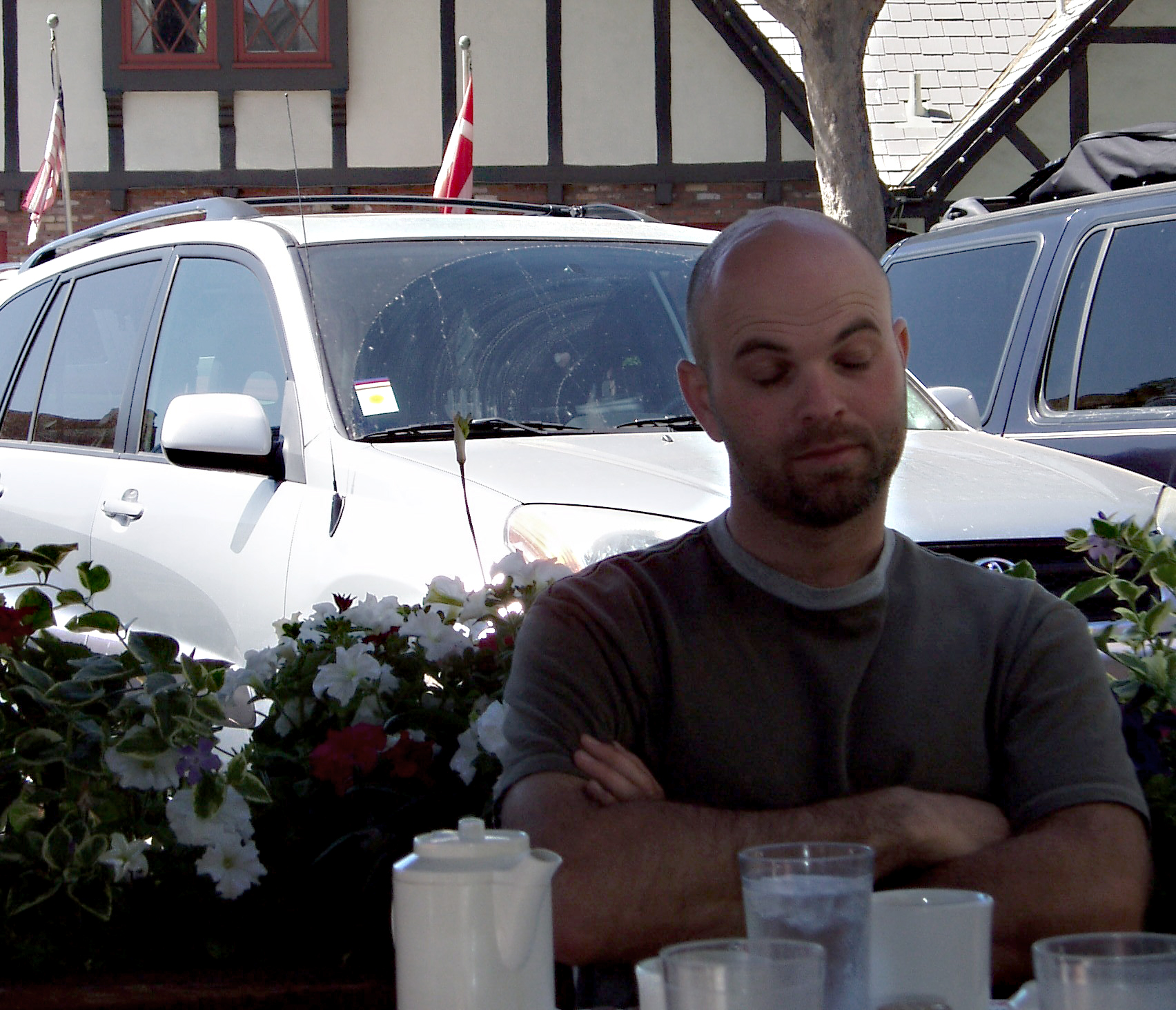 there is a man that is leaning his head on a table