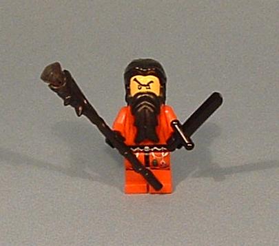 a lego figurine wearing a gas mask and holding two black bats