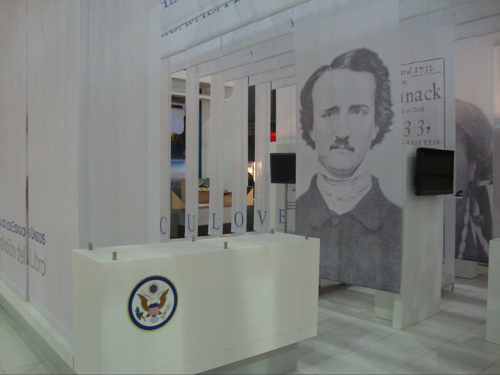 an official portrait in the background behind a podium