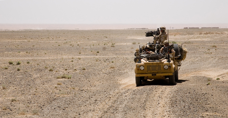 an army truck in the middle of the desert