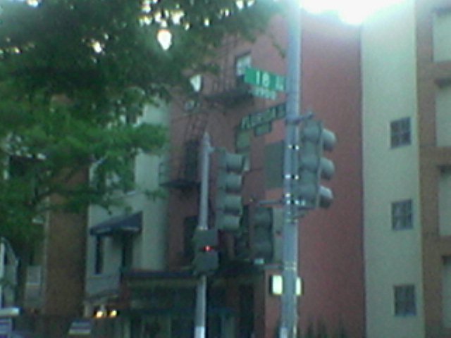 a tall building with many traffic signals at an intersection