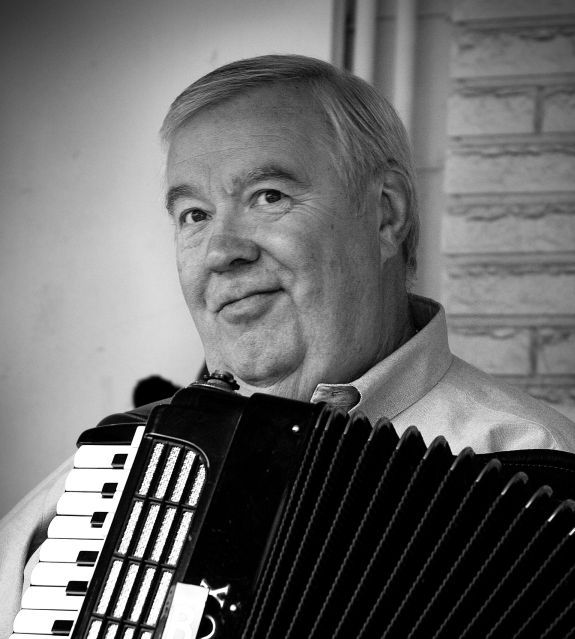 man in a dress shirt with an accordion