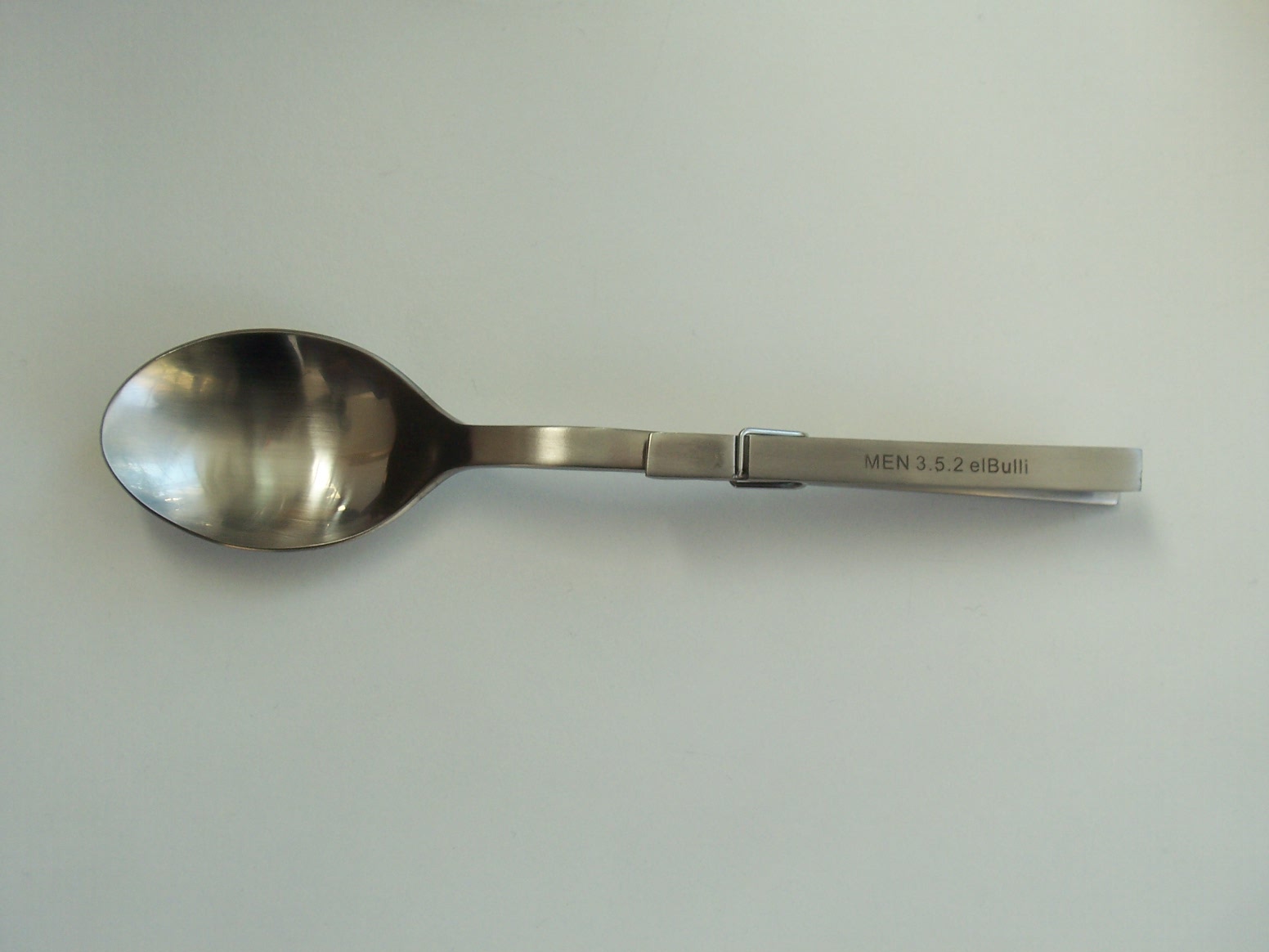 a spoon with a stainless steel spoon handle on it