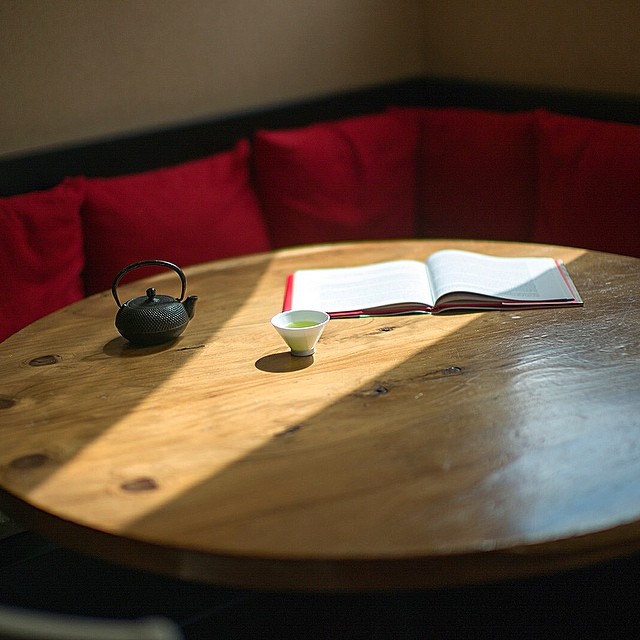 a book on a table in front of a pillow