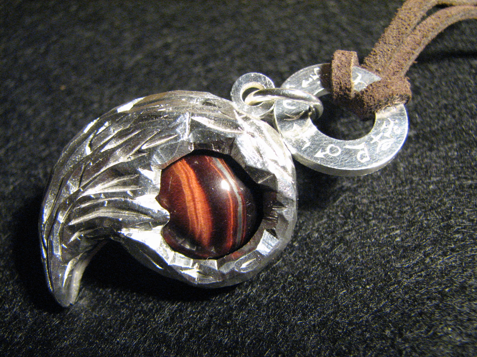 silver pendant with tiger's eye stone inside