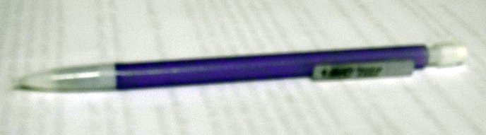 an electronic pen with a green cap and metal tip