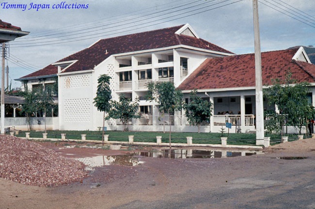 an old building sitting next to a river in a town