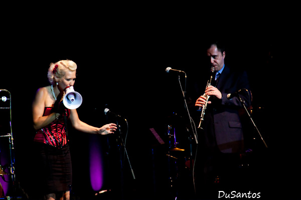 a woman in a red dress and a man with a trumpet