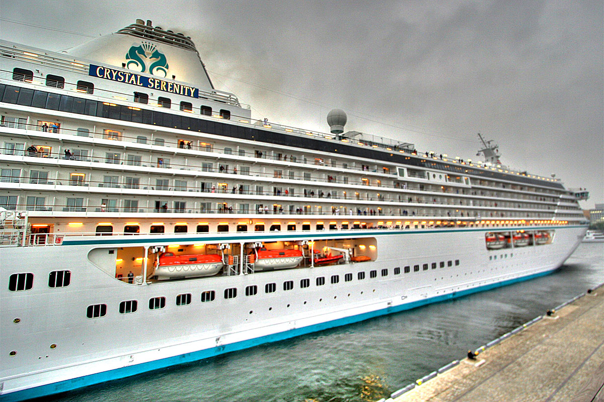 large cruise ship on open water in a city