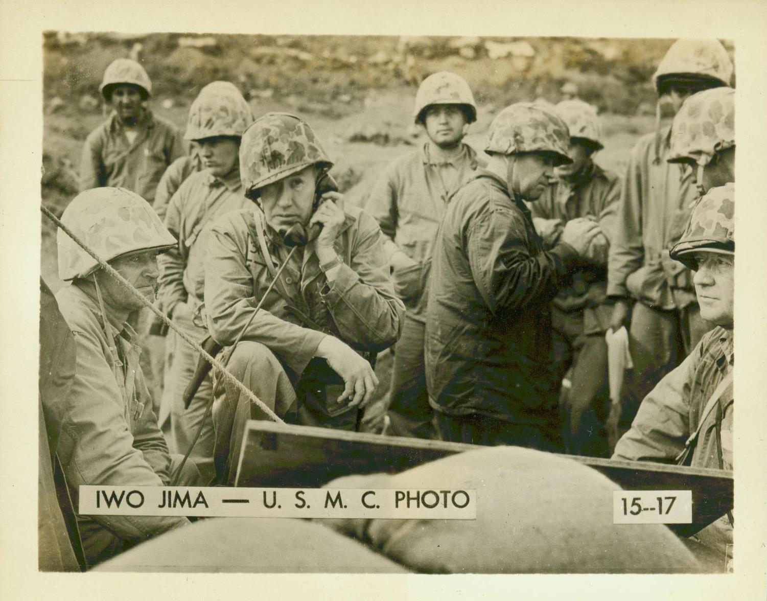 an old picture of soldiers in front of a radio set