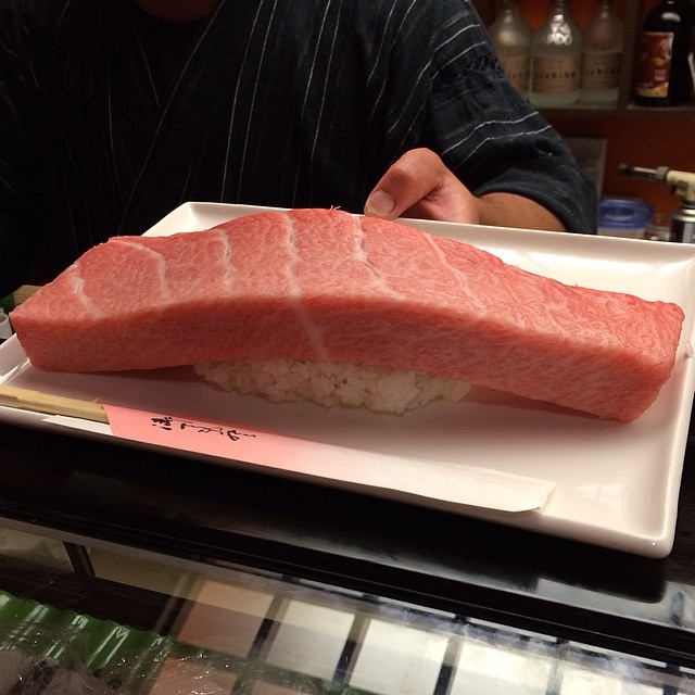 a raw fish fillet sitting on top of sushi