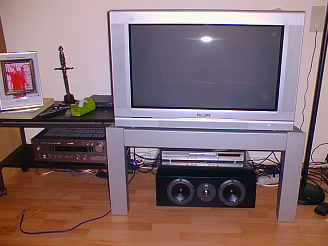 an old television sits on a stand with headphones