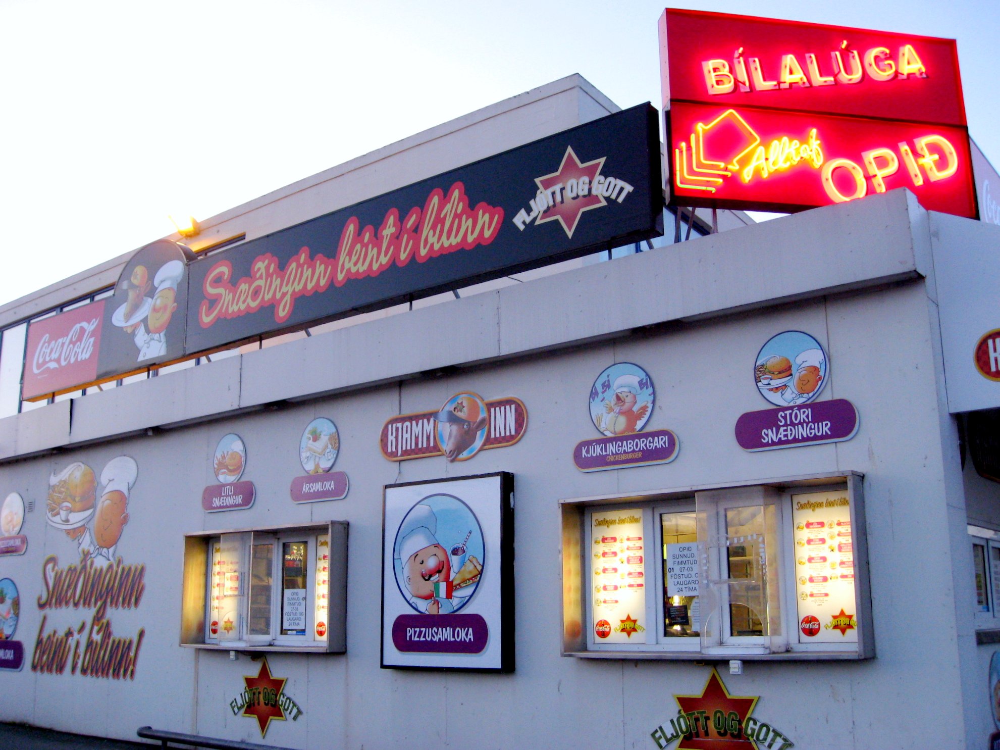 the front side of a restaurant with signs for all kinds of food