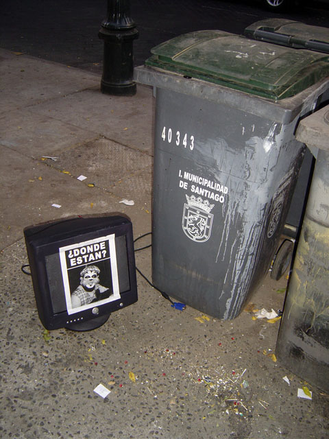 the garbage can next to the electronic box is by the street