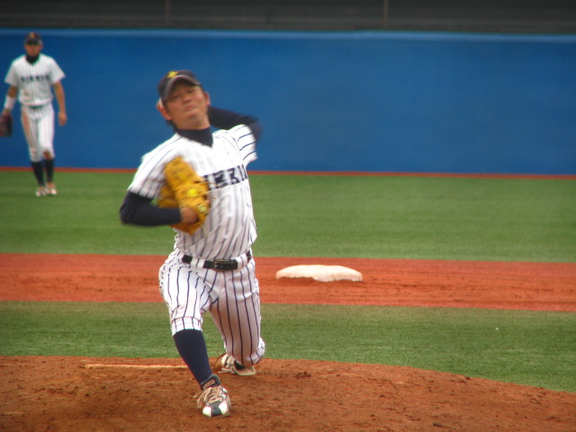 the pitcher is wearing a catchers mitt while playing baseball