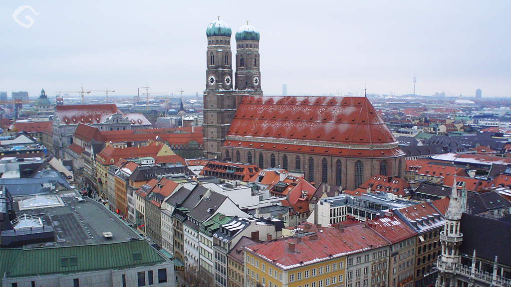 large buildings stand with bright red roofs in a city