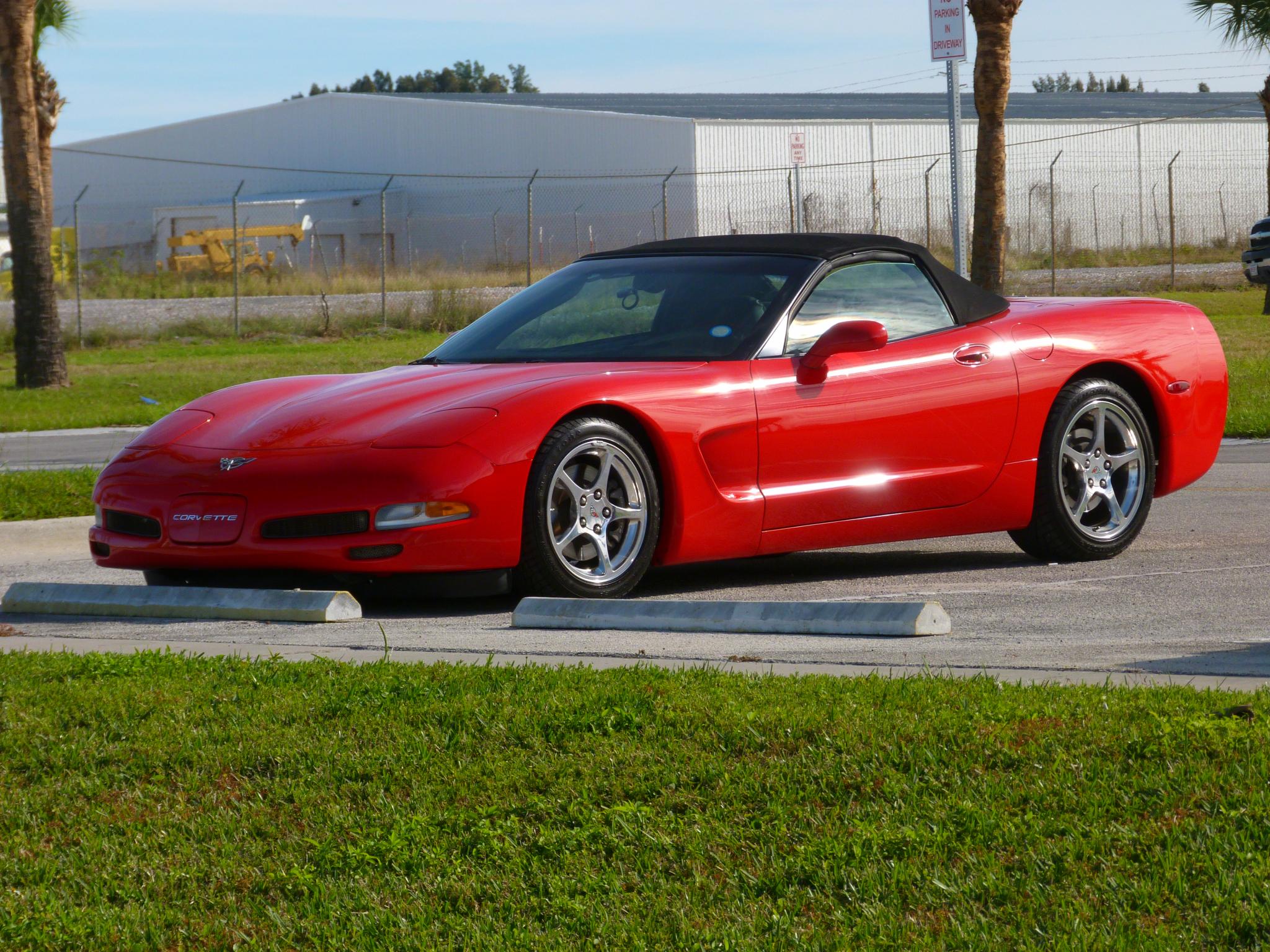 the sports car is parked on the side of the street