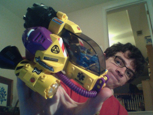 man holding yellow and purple toy with light up arms