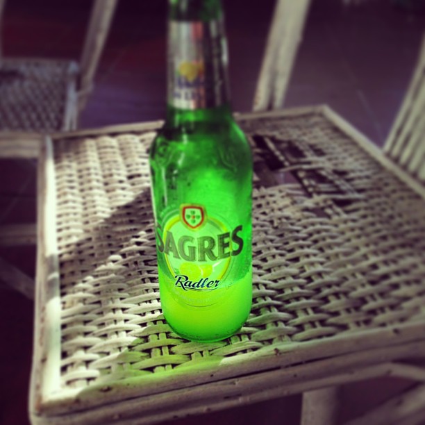 a bottle of beer sitting on top of a chair