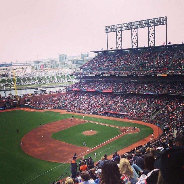 a group of people that are standing at a baseball field