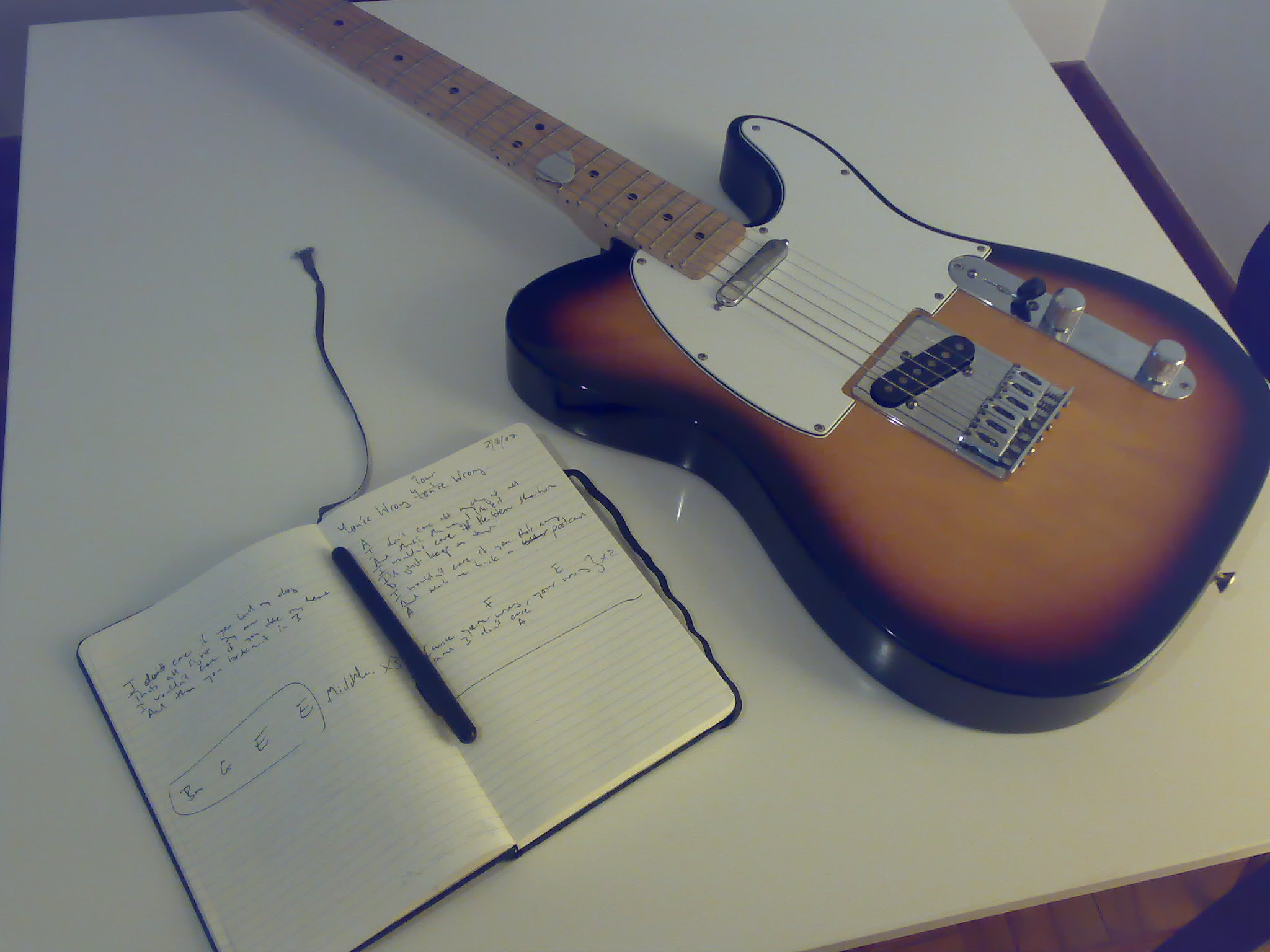 a note book with a guitar and an electric pen