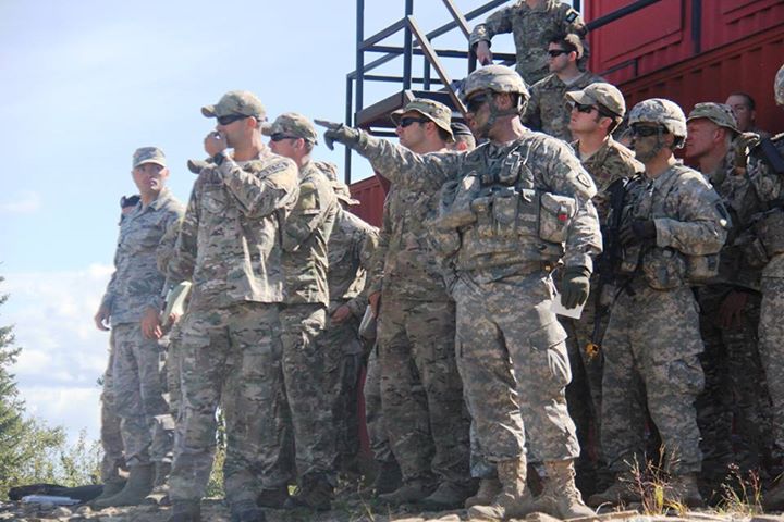 army personnel and men in uniform saluting each other