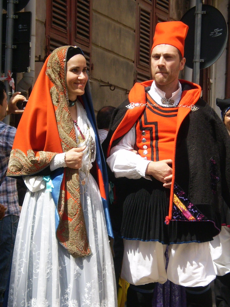an orange hat a woman and a man wearing costume