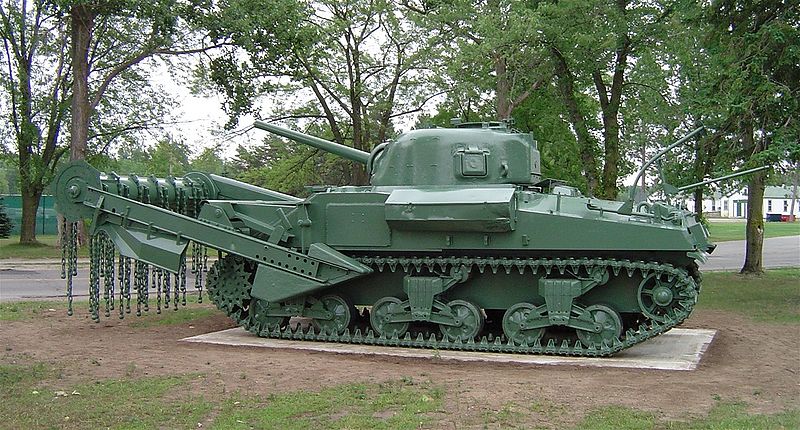 this green military tank is on display in a park