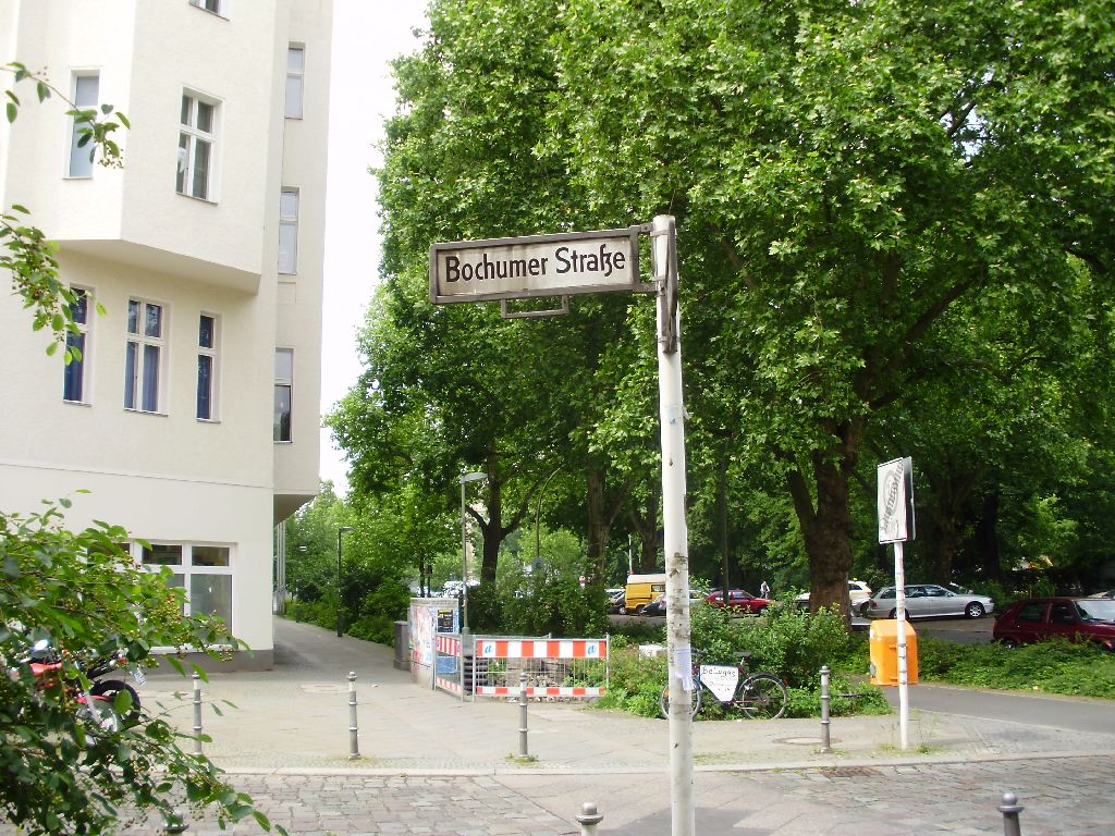 the street sign is in front of some trees