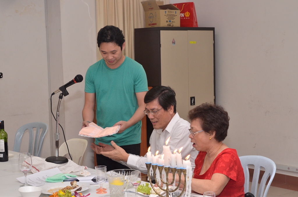a family prepares a cake for a birthday party