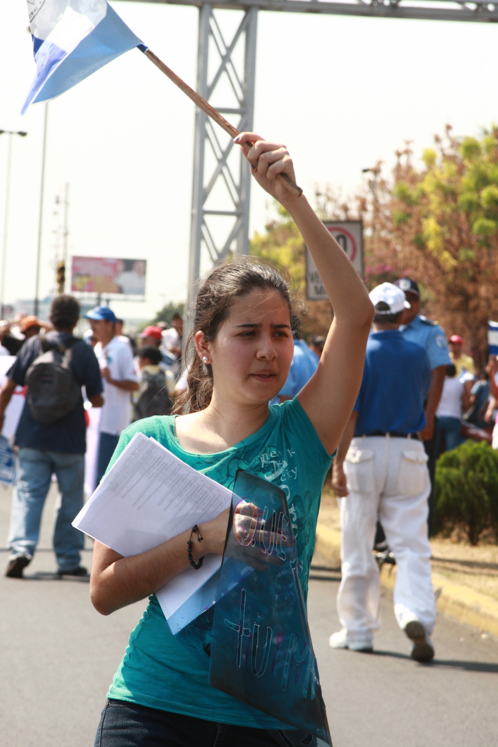 a woman holding a flag while standing next to other people