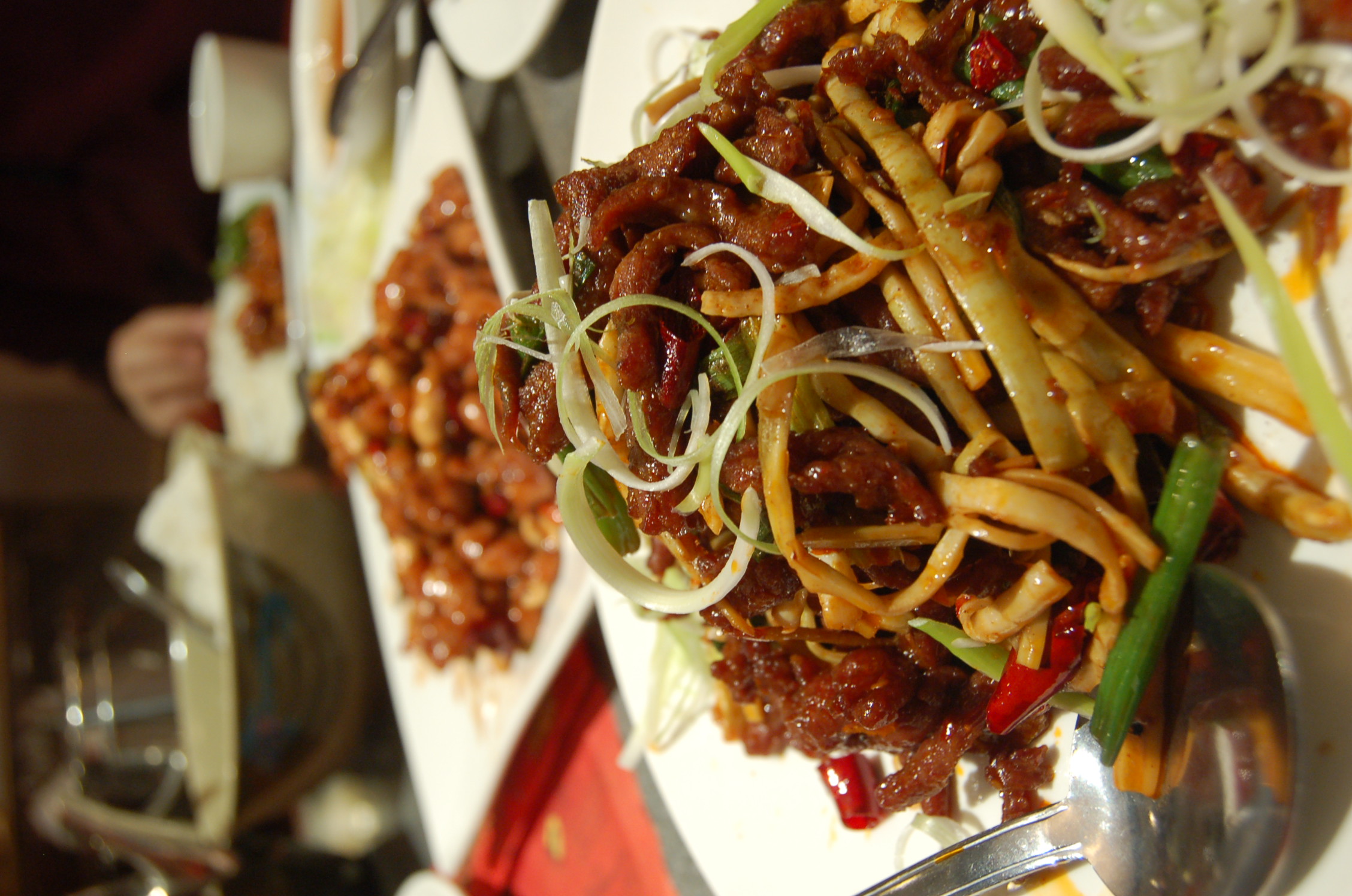 a bowl filled with vegetables and beef in sauce