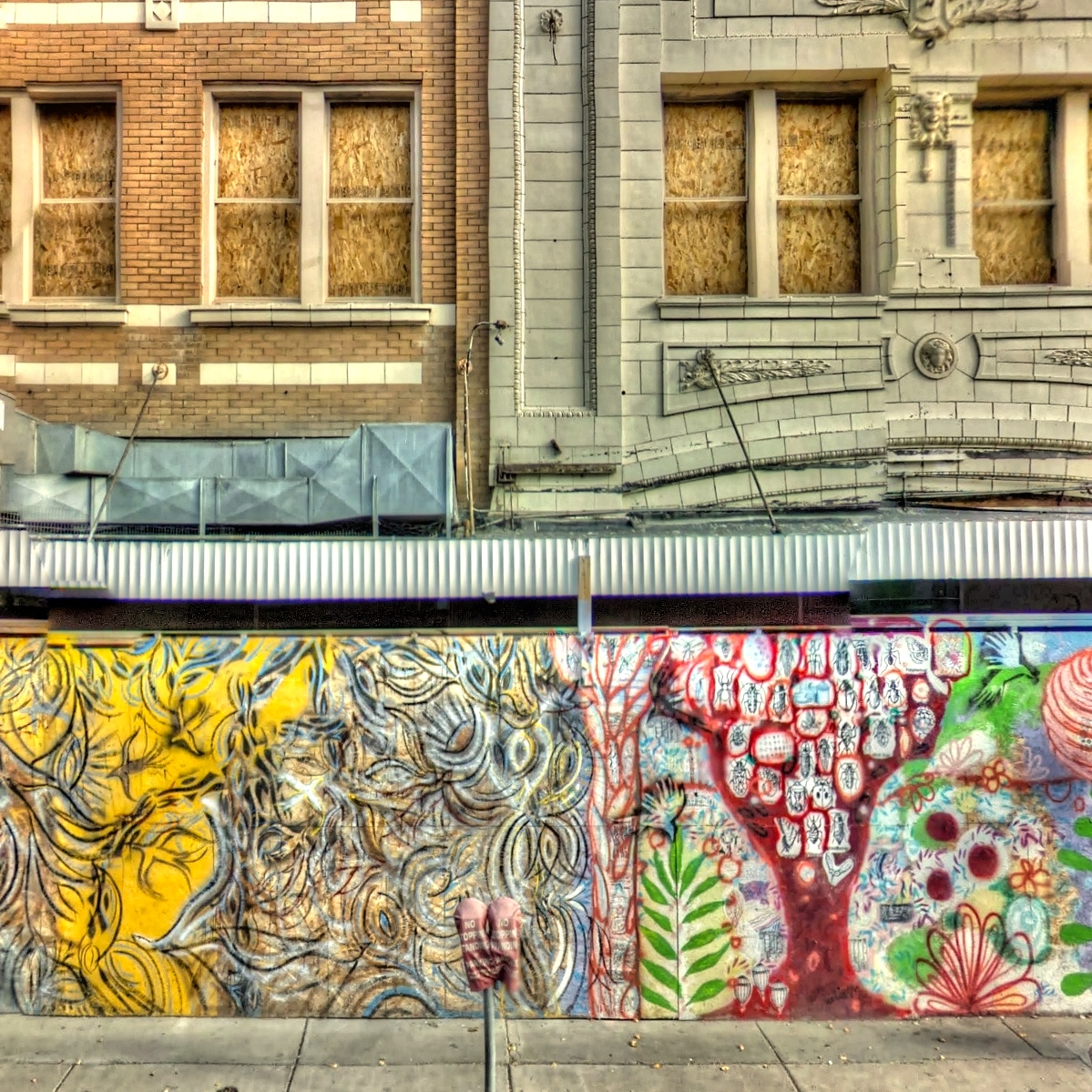 a city wall with murals painted on it