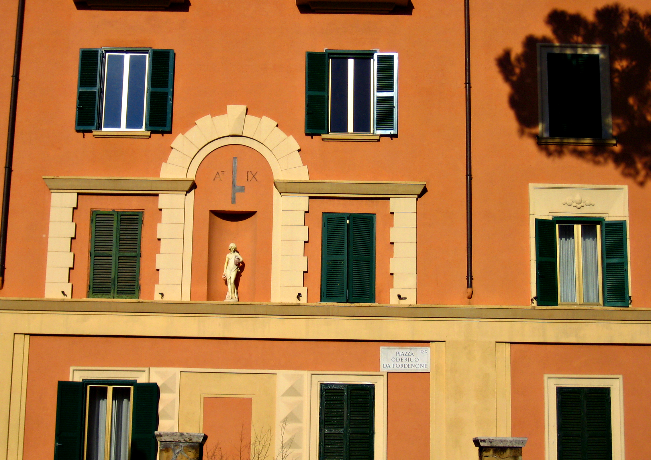 a building has many green windows and shutters