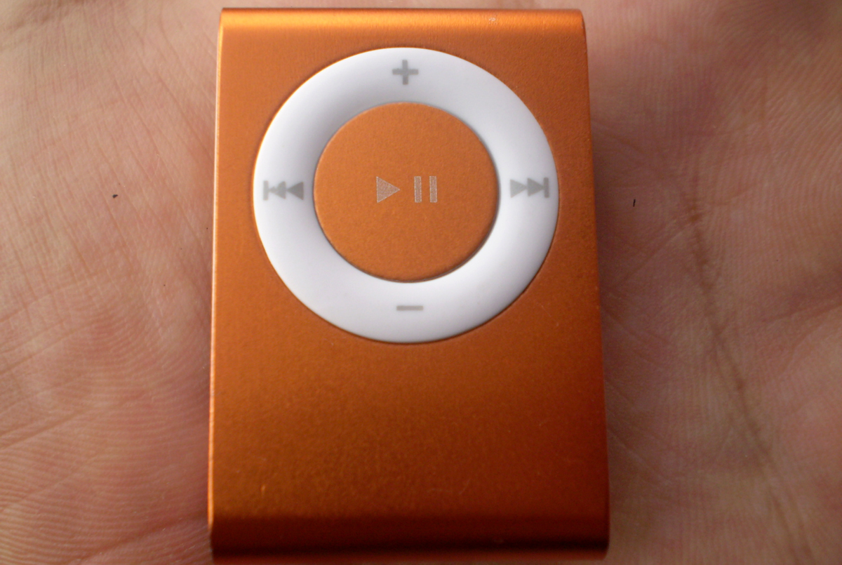 the image shows an orange mp3 player with white ons