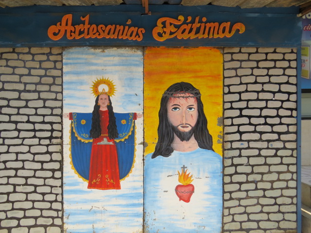 a painting of jesus in the cross is displayed on the side of the church