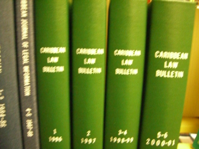 four green books sitting on top of a counter