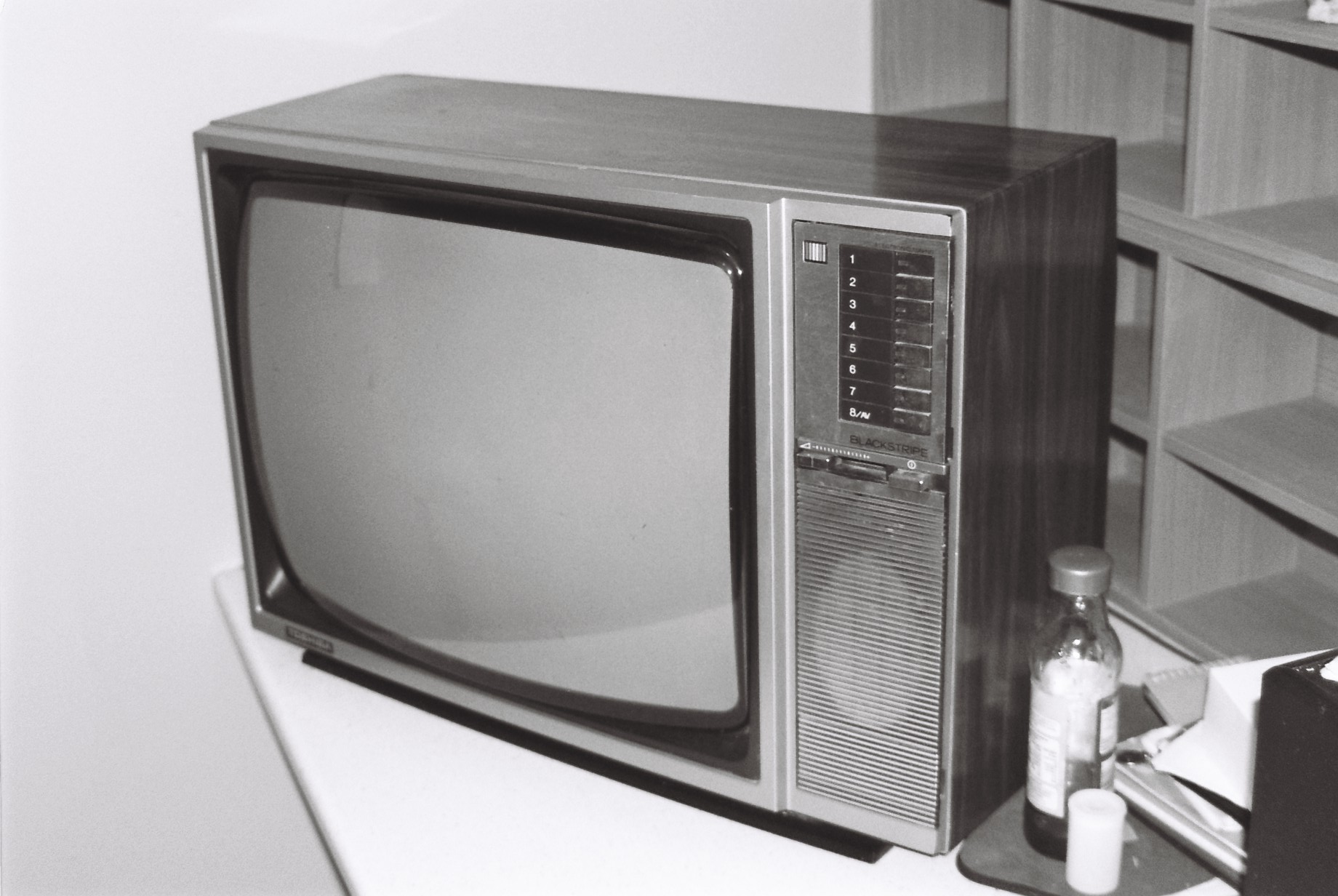 an old television sitting on top of a white desk