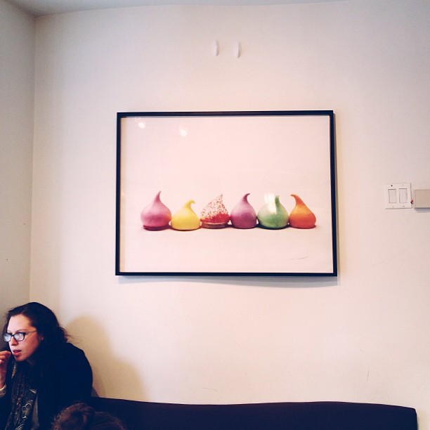 a woman sitting on the couch using her cell phone