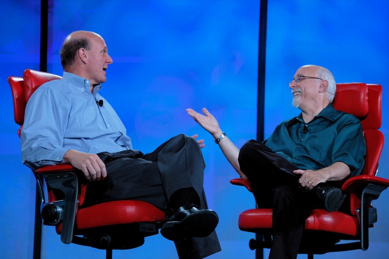 two men sitting in red chairs having an interview