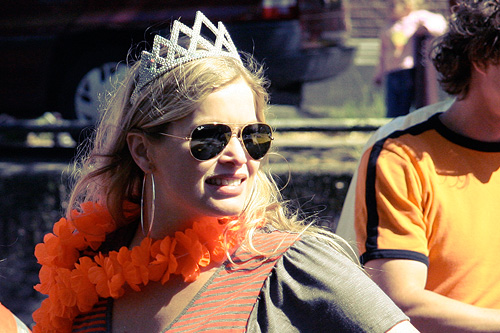 a woman wearing sunglasses and an orange ribbon