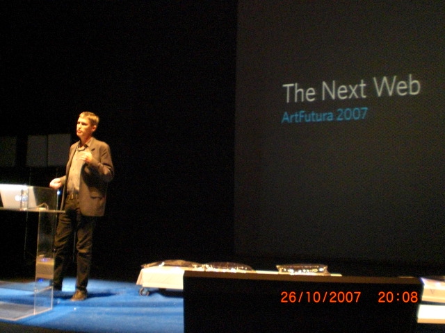 man standing on a stage speaking at a conference