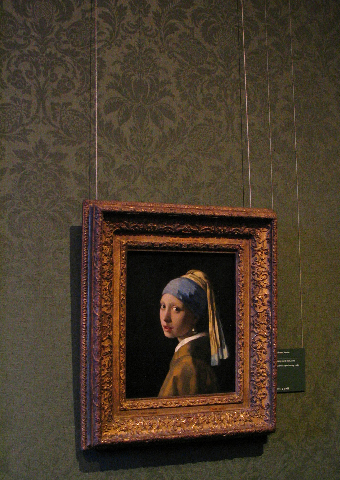 a painting of a girl with a pearl ear