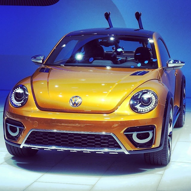a volkswagen car on display in front of a crowd