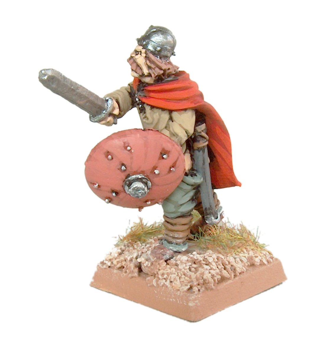 a miniature warrior stands on his sword and shield