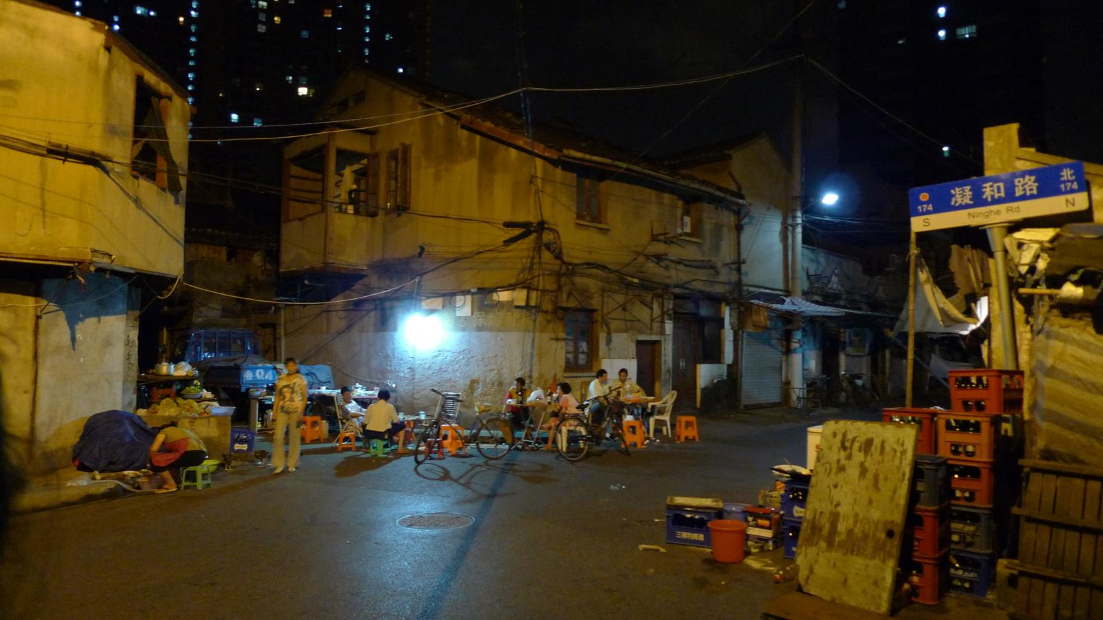 people gathered together in an alley at night